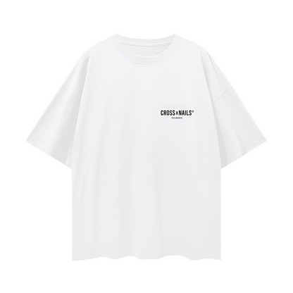 Front and back flat lay images of the Crossxnails® Oversize Tee in Lucent White, displaying the minimalist logo on the front and bold branding on the back.